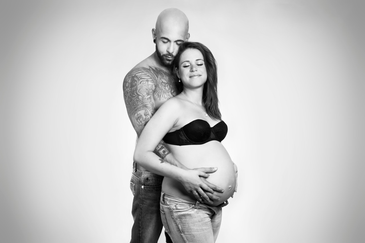 Ein schwangeres Paar in inniger Pose – Babybauchshooting